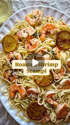 a white plate topped with pasta and shrimp