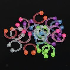 an assortment of pacifiers on a black background