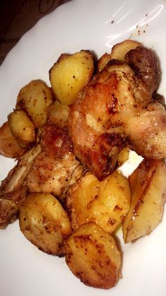 chicken and potatoes on a white plate ready to be cooked in the oven or used as an appetizer