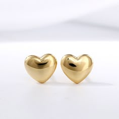 The perfect anytime surprise, these whimsical heart-shaped fashion stud earrings lend a touch of shine to her attire. Crafted in sterling silver, each dainty puffed heart gleams with anytime appeal. So sweet and charming, these heart stud earrings are sure to become an instant favorite.Weight: 1.16 gWidth: 6.6 mmHeight: 5.8 mmThickness: 2.2 mmMaterial: 925 SilverPlating Color: Yellow Gold Gold Heart Shaped Earrings, Heart Shaped Gold Earrings, Luxury Yellow Gold Heart Earrings With Cubic Zirconia, Golden Heart Earrings, Affordable Vintage Heart-shaped Jewelry, Heart Shape Earrings Gold, Heart Earrings Gold, Heart Gold Earrings, Pink Luxury Aesthetic