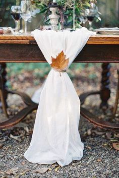 the table is set with an autumn leaf napkin