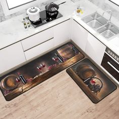 two kitchen mats with wine glasses and bottles on them in the middle of a kitchen