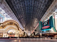 the inside of a shopping mall with lots of tall buildings