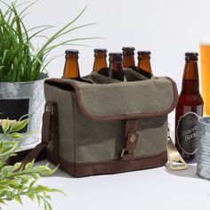 an assortment of beer bottles and cans on a table