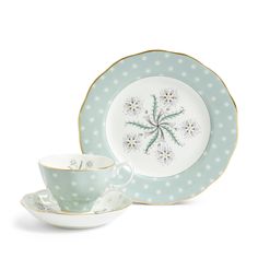 a tea cup and saucer sitting next to each other