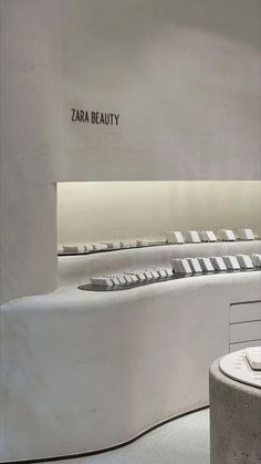 the interior of a store with white furniture and signs on the walls that read'zara beauty '