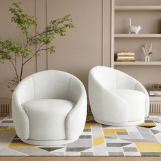 two white chairs sitting next to each other on top of a rug