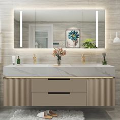 a bathroom vanity with two sinks and large mirrors above it, along with a rug on the floor