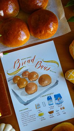 an advertisement for bread buns is displayed on a table with other baked goods around it