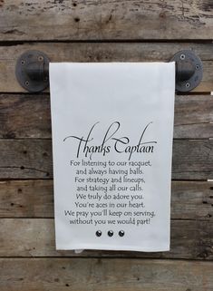 a white towel hanging on the side of a wooden wall with a poem written in cursive writing