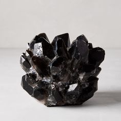 a black rock sitting on top of a white table