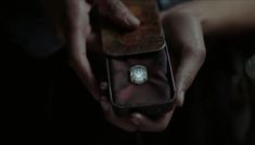 a person is holding an old watch in their hand and it's inside the case