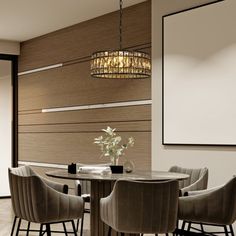 a dining room table with four chairs and a chandelier hanging from the ceiling