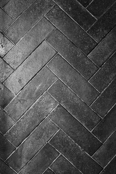 a black and white photo of a brick floor