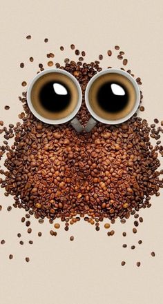 an owl made out of coffee beans with eyes on it's head, surrounded by coffee grains