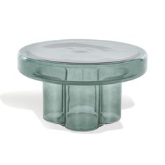 a round glass table with two legs and a circular base on the top, in front of a white background