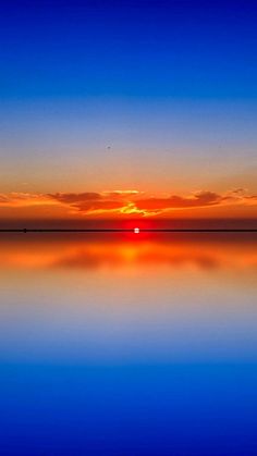 the sun is setting over the water and reflecting it's reflection in the water