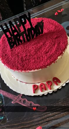 a red and white birthday cake with the words happy birthday on it's top