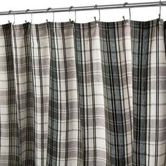 a shower curtain with black and white plaid fabric hanging from it's metal rod