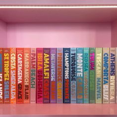 a pink shelf filled with lots of colorful books