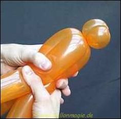 a person holding an orange plastic bottle in their hand