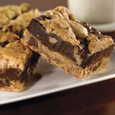 chocolate chip cookie bars on a plate next to a glass of milk