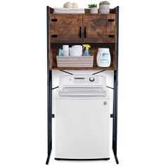 a white washer sitting next to a wooden shelf