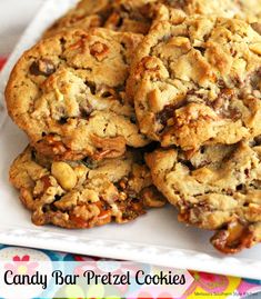 several cookies on a plate with the words candy bar pretzel cookies