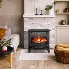 a living room filled with furniture and a fire place next to a brick wall in front of a fireplace