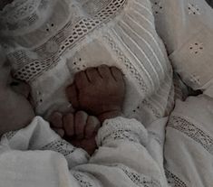 a baby wrapped in white is laying down