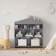 a stuffed llama sitting in front of a bookshelf filled with children's toys