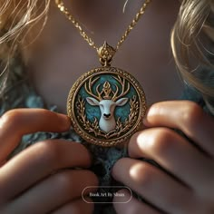 a woman is holding a necklace with a deer head on it