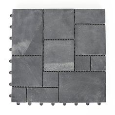 a gray tile with small squares and holes on the side, all in different sizes