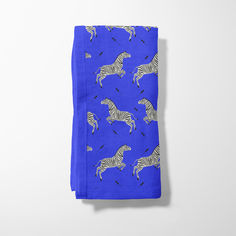 a blue napkin with zebras on it