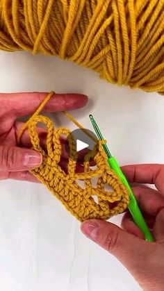 someone crocheting a piece of yellow yarn