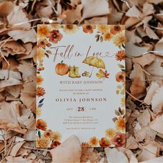 a fall in love baby shower with umbrellas and pumpkins on the ground surrounded by leaves