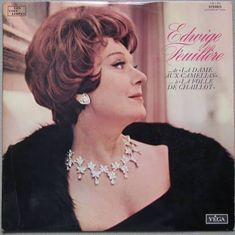 an album cover with a woman wearing a necklace and earrings