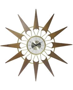 a clock that is made out of wood and has metal spikes on the front side