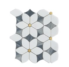 a white and black flower tile with gold accents on the bottom, in an irregular pattern