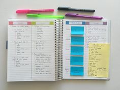 an open notebook with notes and pens on it