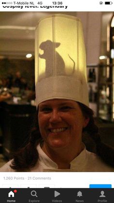 a woman wearing a white hat with a shadow of a mouse on it