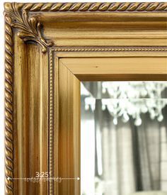 an ornate gold framed mirror with roped edges