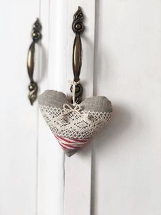 a heart hanging from the side of a white door