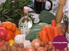 there are many different fruits and vegetables on the table with juices, nuts, and other items