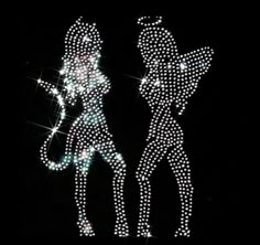 an image of two people that are made out of diamonds on black background with sparkles