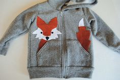 a gray jacket with a red and white fox on it