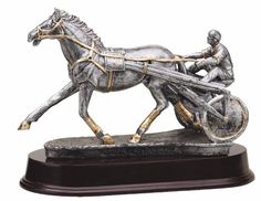 Silver & gold resin statue of a race horse & jockey using a sulky in the middle of a harness race. It's mounted on a dark maroon wood base that includes an engraving plate for personalization. Racing Trophy, Horse Jockey, Race Horse, Harness Racing, Resin Statue, Horse Racing, Dressage