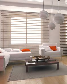 a modern living room with white furniture and orange accents