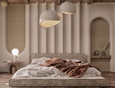 a bed with two lamps hanging above it