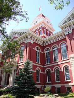 a large red building with a tree in front of it